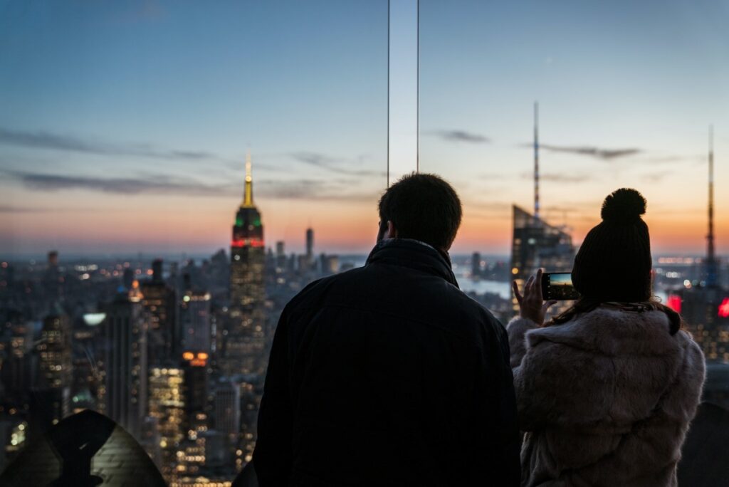 Romantic couple looking at sunset at a New york rooftop