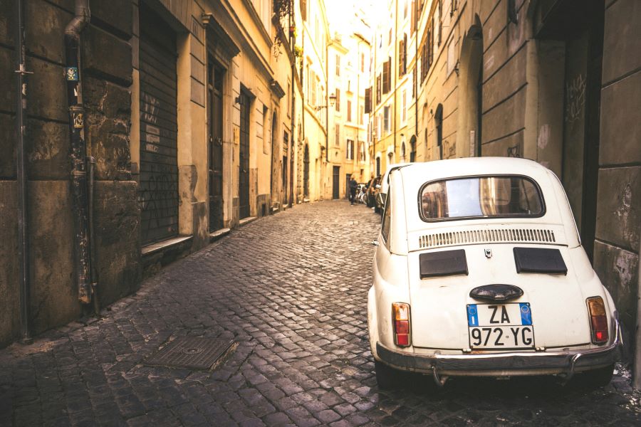 Old Italian street with a white car