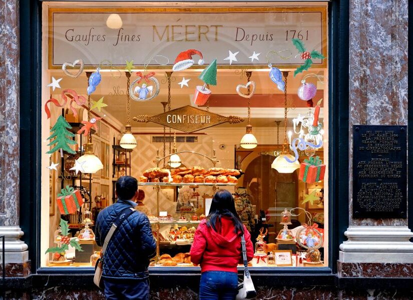 Couple looking at holiday decorations of a store window