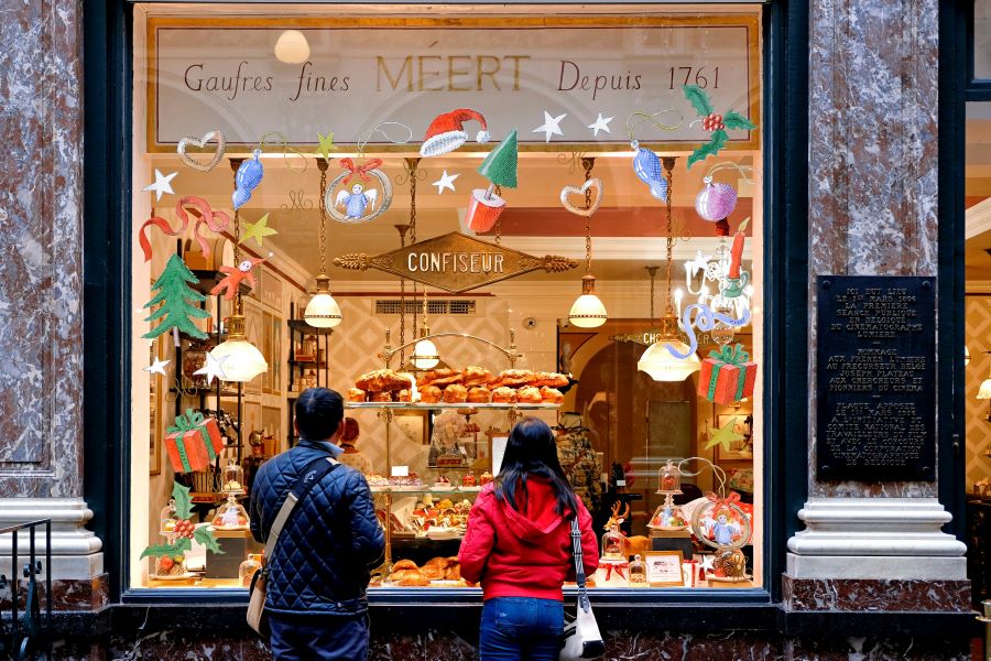 Couple looking at holiday decorations of a store window