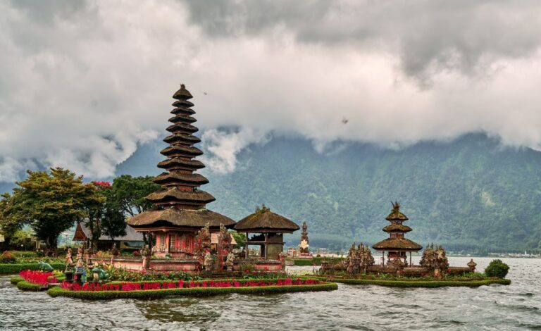 Scenic picture of a buddhist temple on the lake surrounded by mountains in Bali