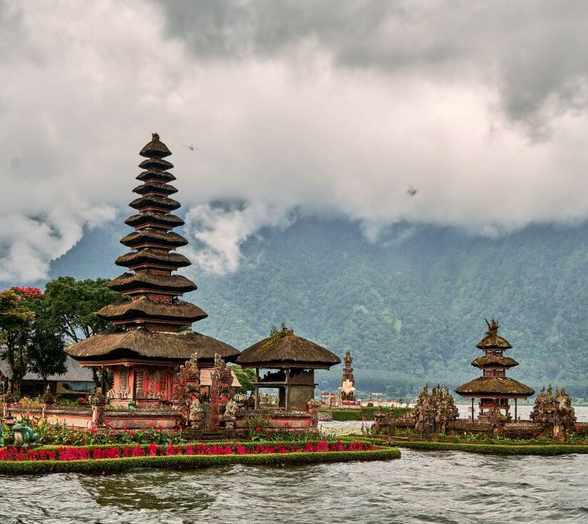 Scenic picture of a buddhist temple on the lake surrounded by mountains in Bali